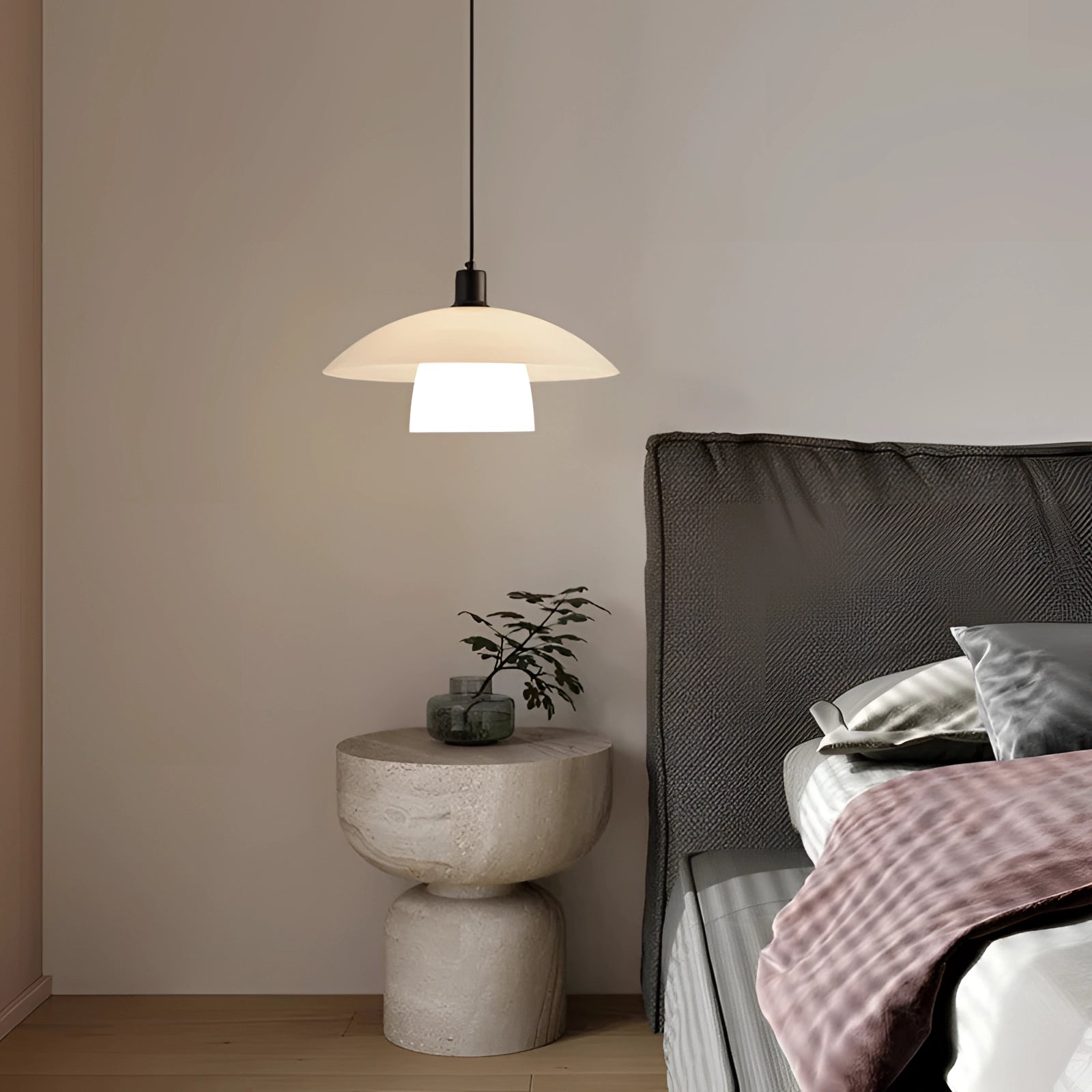 Modern Scandinavian white dome pendant lights hanging over a kitchen island, with wooden and textile elements, surrounded by a comfortable, well-designed interior featuring plants and grey accents.