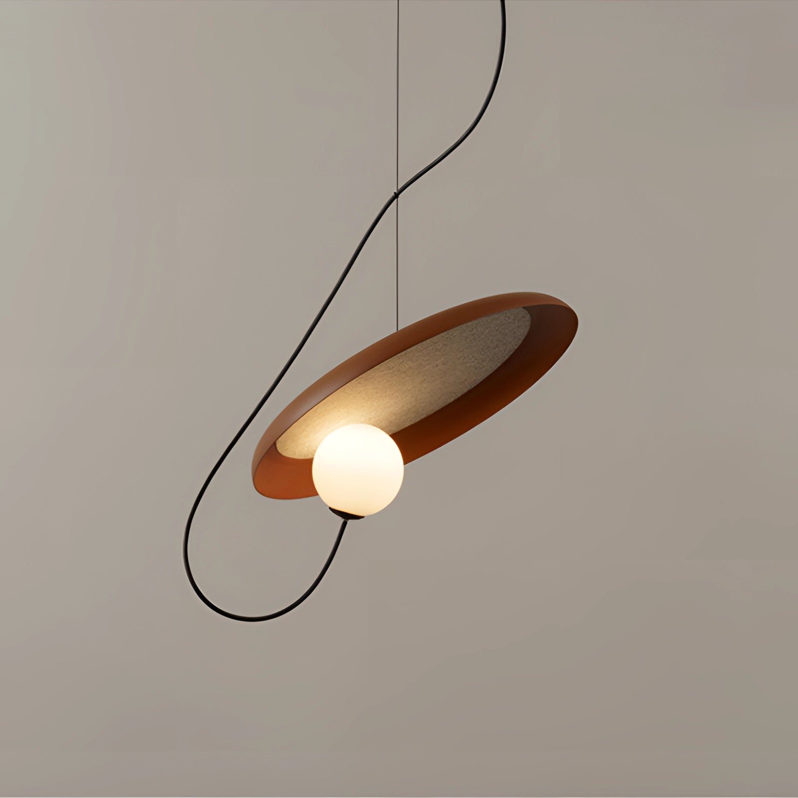 Modern Scandinavian pendant light with a minimalist design featuring a wooden accent and a circular metal frame, suspended from the ceiling.