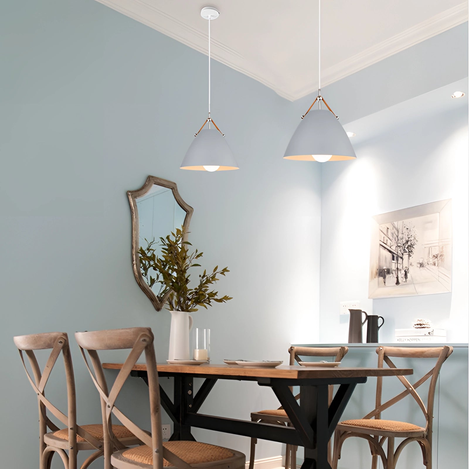 Modern Scandinavian pendant light in a sleek black and white design, stylishly hanging above a contemporary interior setting featuring wooden furniture, a small plant, and minimalistic decor elements.