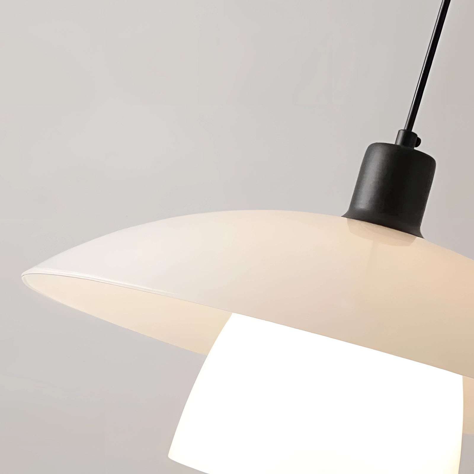 Modern Scandinavian white dome pendant lights hanging above a kitchen island, featuring a sleek design with wood and metal elements.