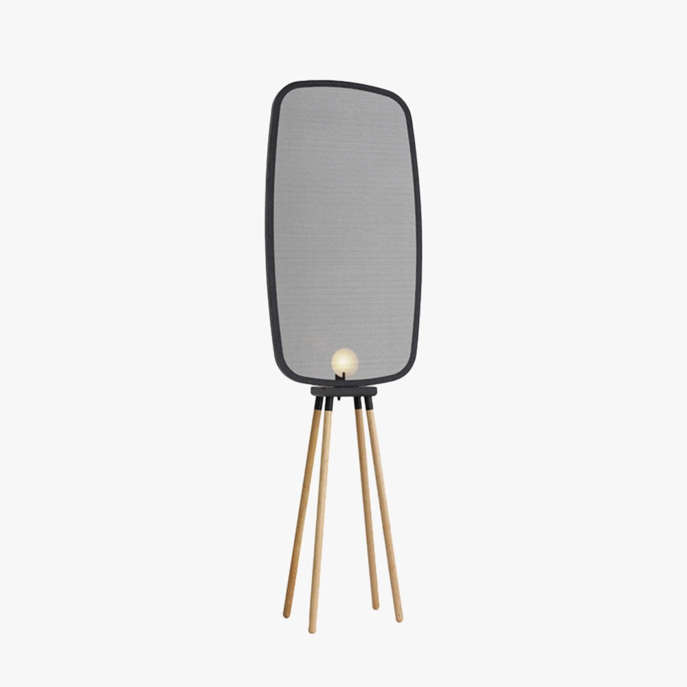 Modern Scandinavian tripod floor lamp with an oval shade, featuring a warm white light. The lamp is positioned beside a chair, blending contemporary design with a cozy ambiance.