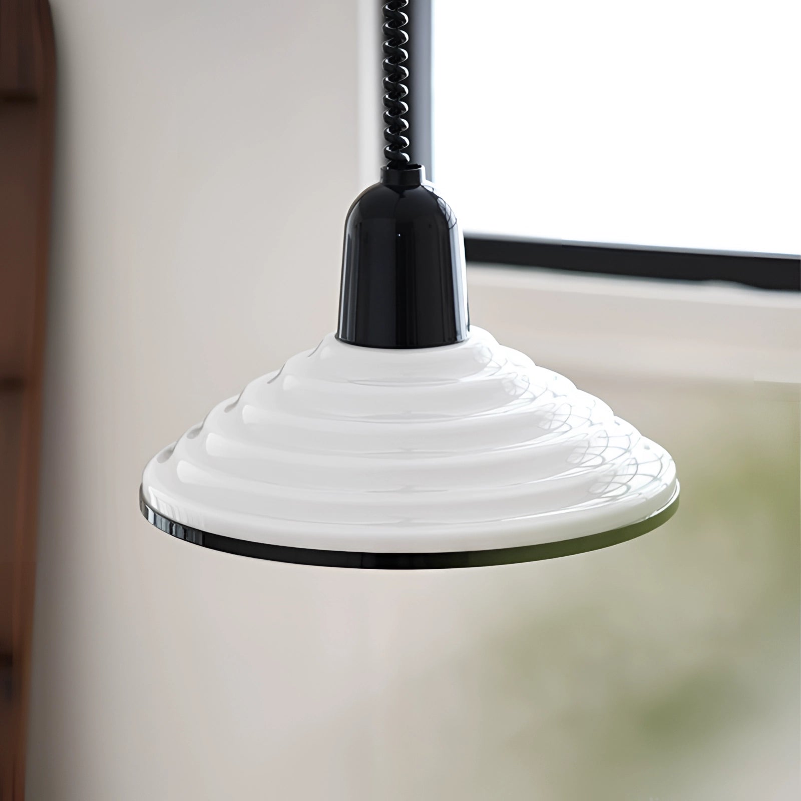 Modern Scandinavian white acrylic pendant light with a minimalistic design, featuring a cone-shaped lampshade and wood accents, suspended from a ceiling fixture crafted from metal and composite materials.