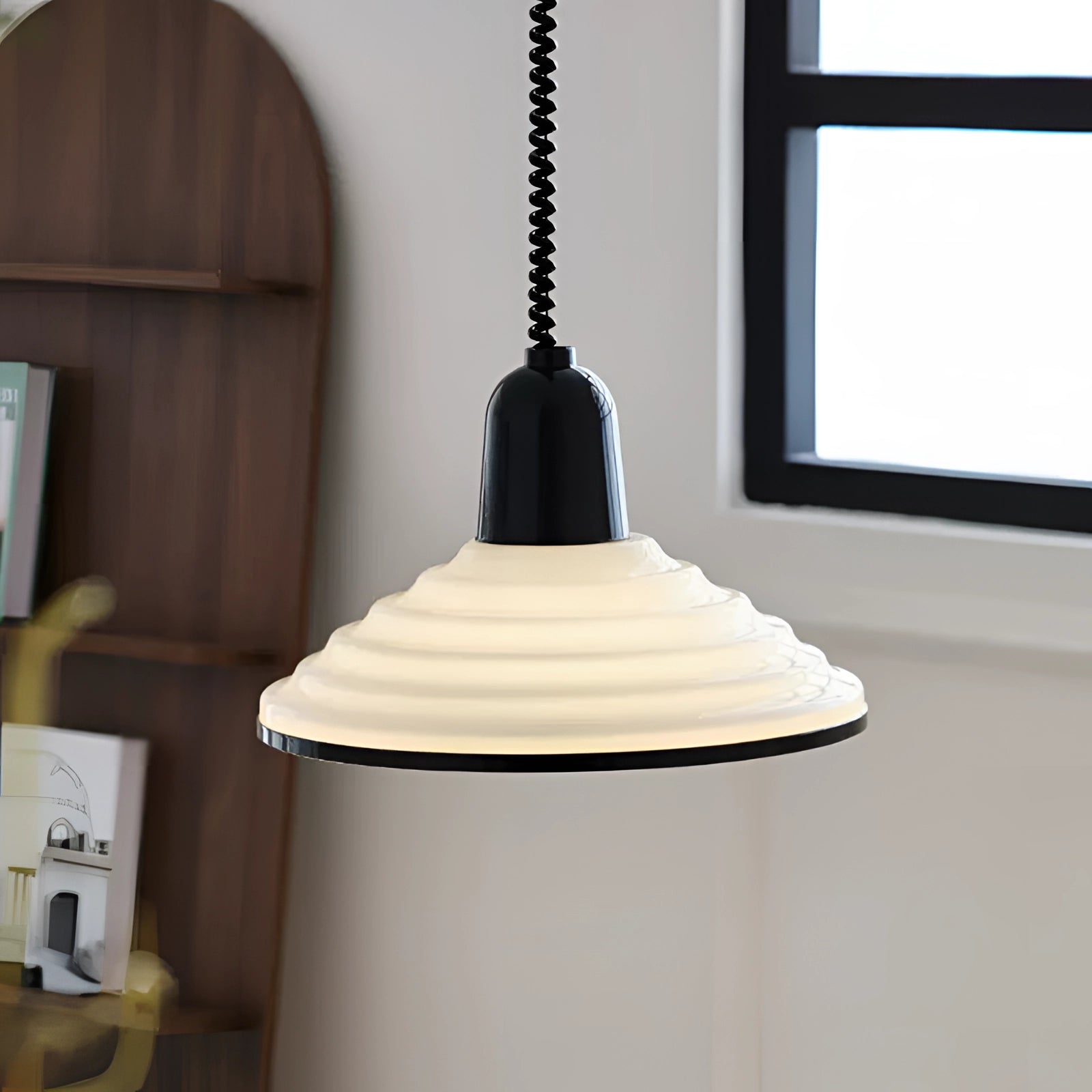 Modern Scandinavian white acrylic pendant light with a minimalistic design, featuring a sleek shade and clean lines, hanging from a ceiling fixture.