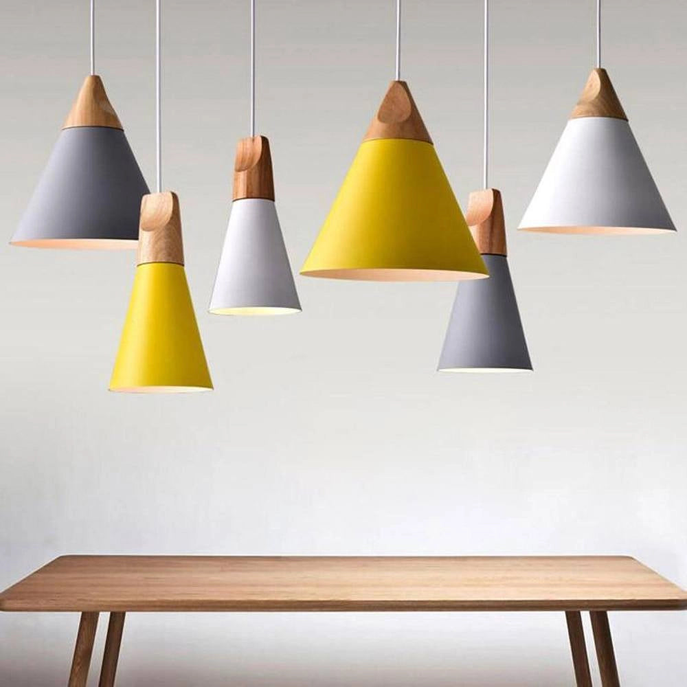 Modern Scandinavian wood pendant light with dual-tone gray and yellow adjustable shade, featuring a cone design and hanging in a stylish interior.