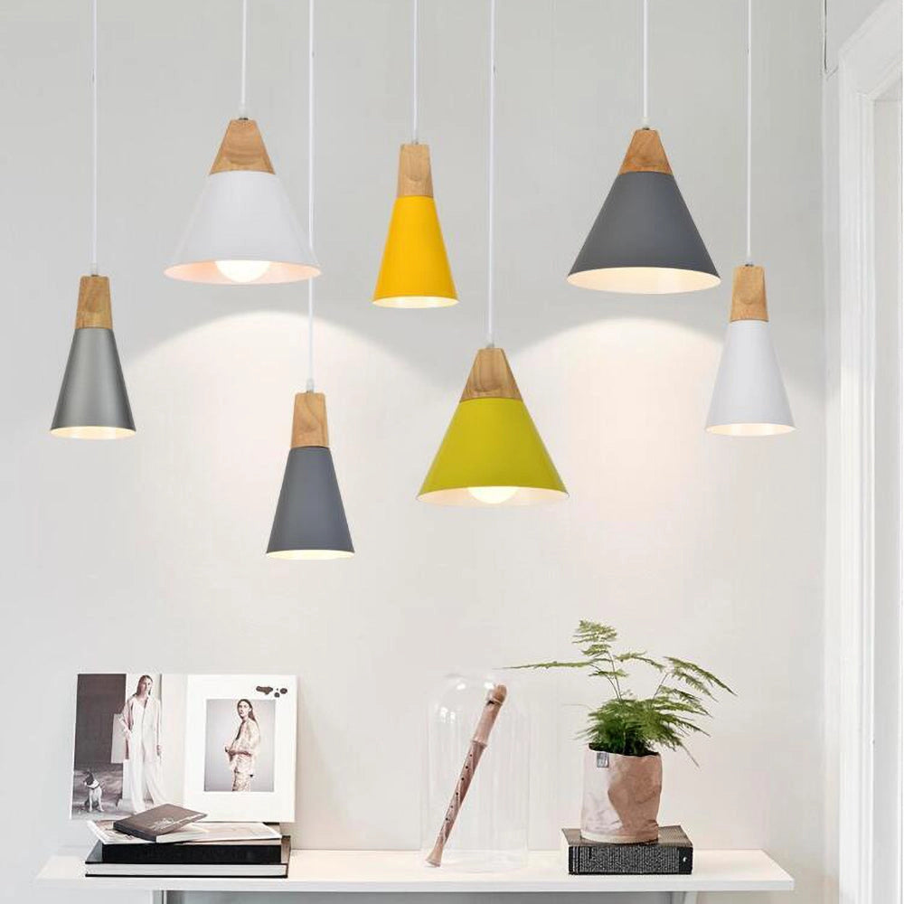Modern Scandinavian wood pendant lights in dual-tone gray and yellow, adjustable, hanging in an interior setting with a houseplant and flowerpot nearby.
