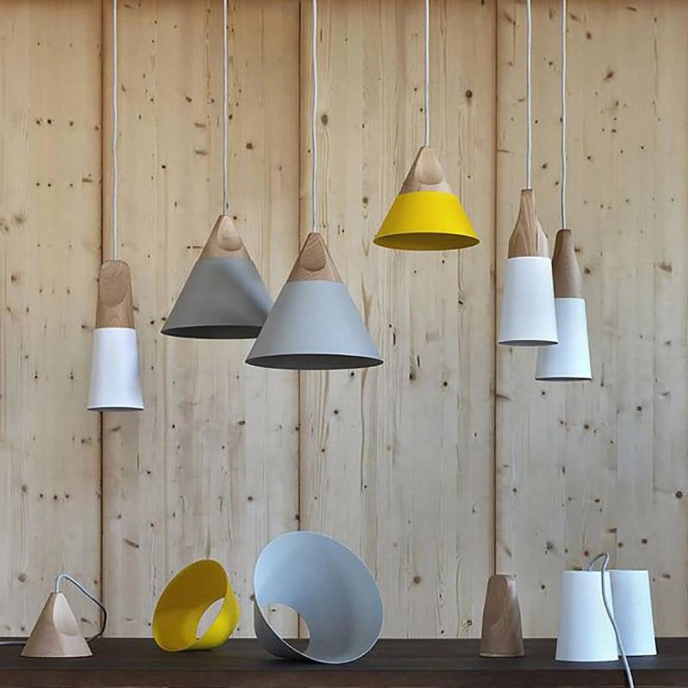 Modern Scandinavian wood pendant lights in dual-tone gray and yellow, hanging in a stylish interior with wooden shelving and contemporary furniture.
