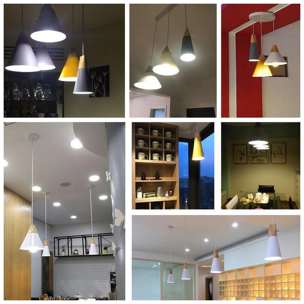 Modern Scandinavian dual-tone gray and yellow wood pendant lights hanging in a contemporary interior setting with large windows and minimalist shelving.