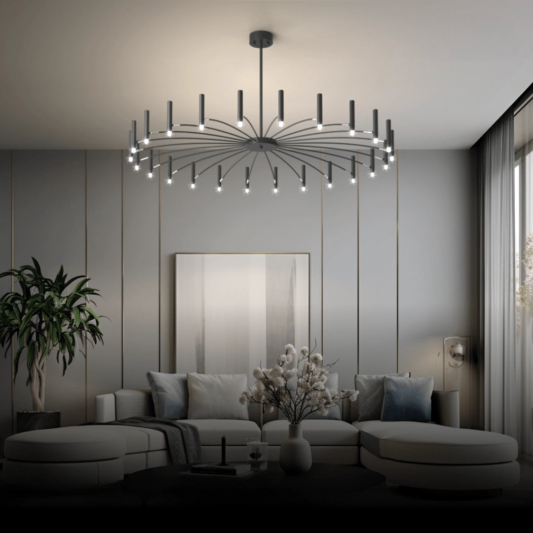 Modern starburst chandelier with 24 candle-style lights in cold white illumination, elegantly hanging in a minimalist interior setting featuring wood accents and contemporary architectural design.