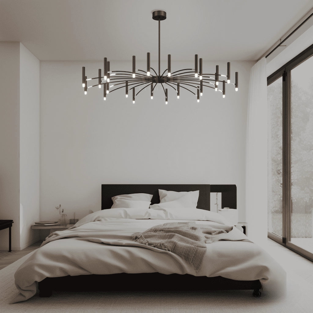 Modern starburst chandelier with 24 candles of mixed lengths in cold white, hanging in a minimalist interior setting, featuring black and wood elements in the decor.
