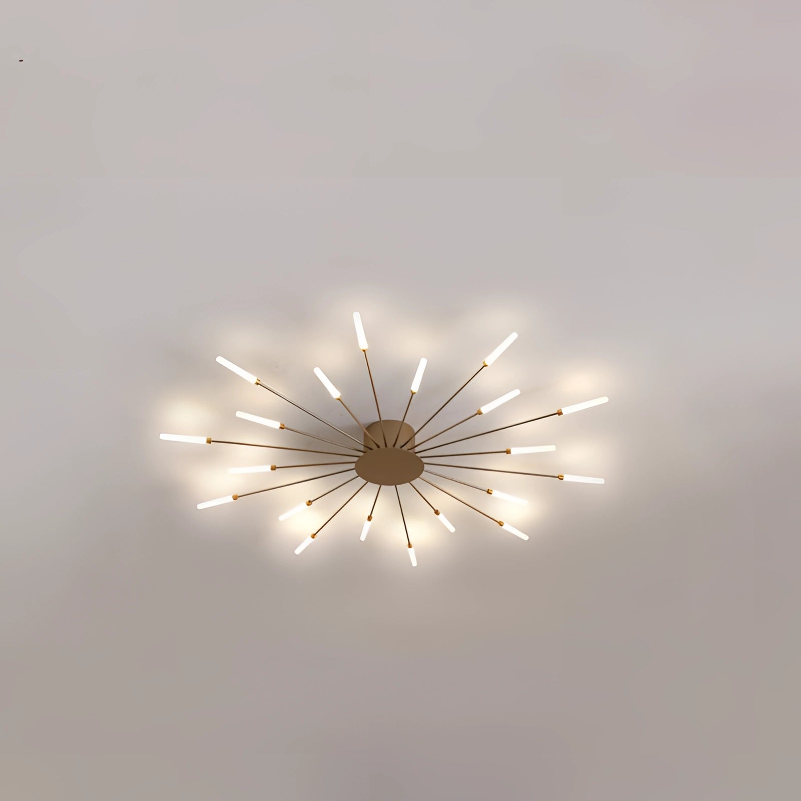 Modern Starburst LED Chandelier in Gold, featuring a sleek black and white design with 20 elongated light bulbs arranged in a radial pattern.