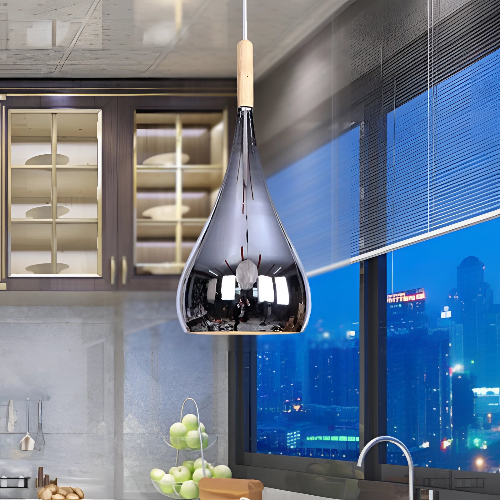 Modern teardrop smoked glass pendant light with chrome accents hanging above a contemporary kitchen countertop, surrounded by wooden cabinetry and sleek interior design elements.