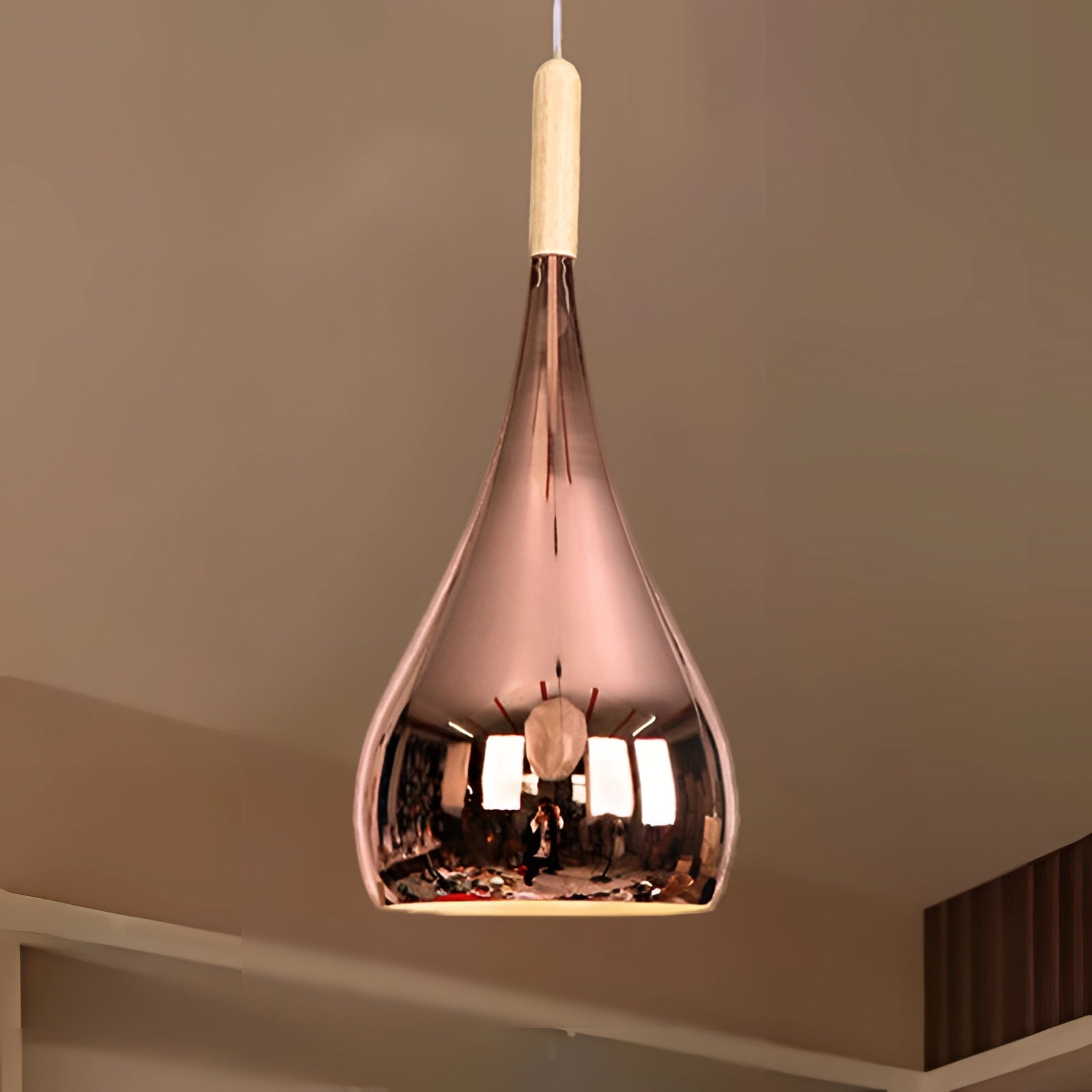 Modern teardrop smoked glass pendant light with a sleek design, featuring a blend of wood and metal elements, suspended from the ceiling, ideal for contemporary kitchen spaces.