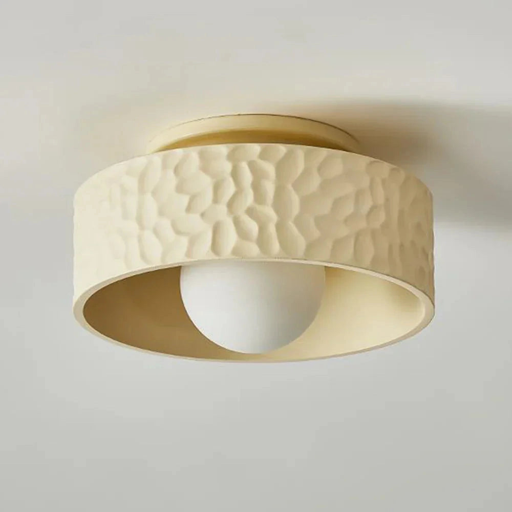 Modern textured circular LED ceiling light flush mount fixture on a beige ceiling.