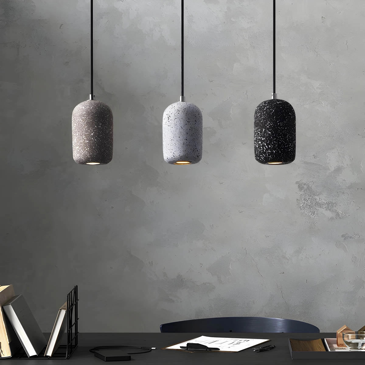 Modern textured concrete pendant lights in a sleek design, featuring a combination of white, black, and grey tones, suitable for contemporary kitchen settings.