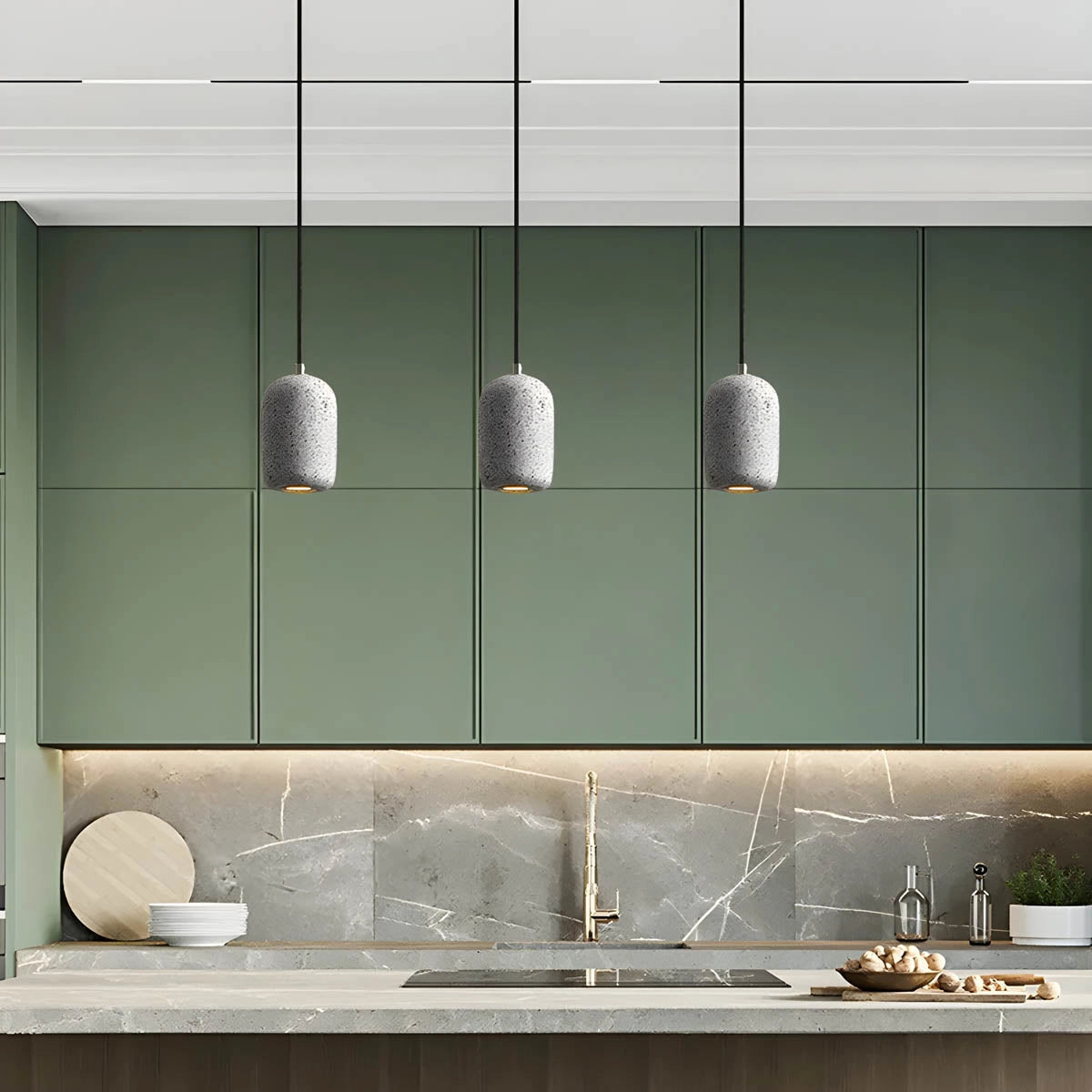 Modern textured concrete pendant lights hanging in a sleek kitchen, featuring a wooden shelf beneath a large window, creating a bright and stylish interior design.
