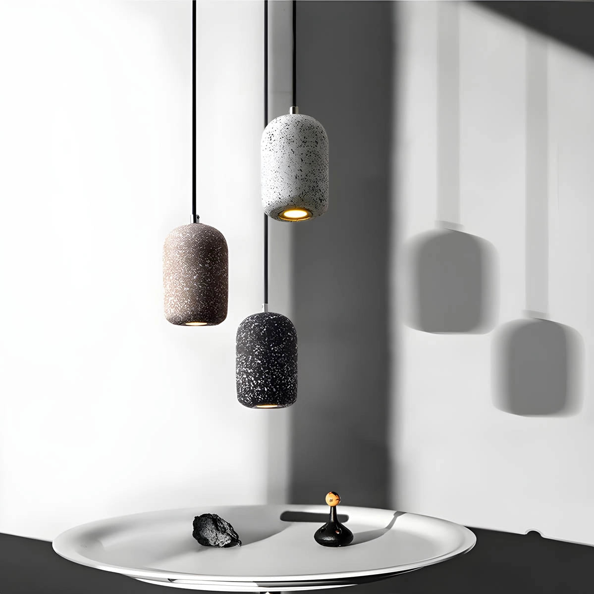 Modern textured concrete pendant lights in a sleek kitchen setting, featuring a rectangular design with a grey finish.