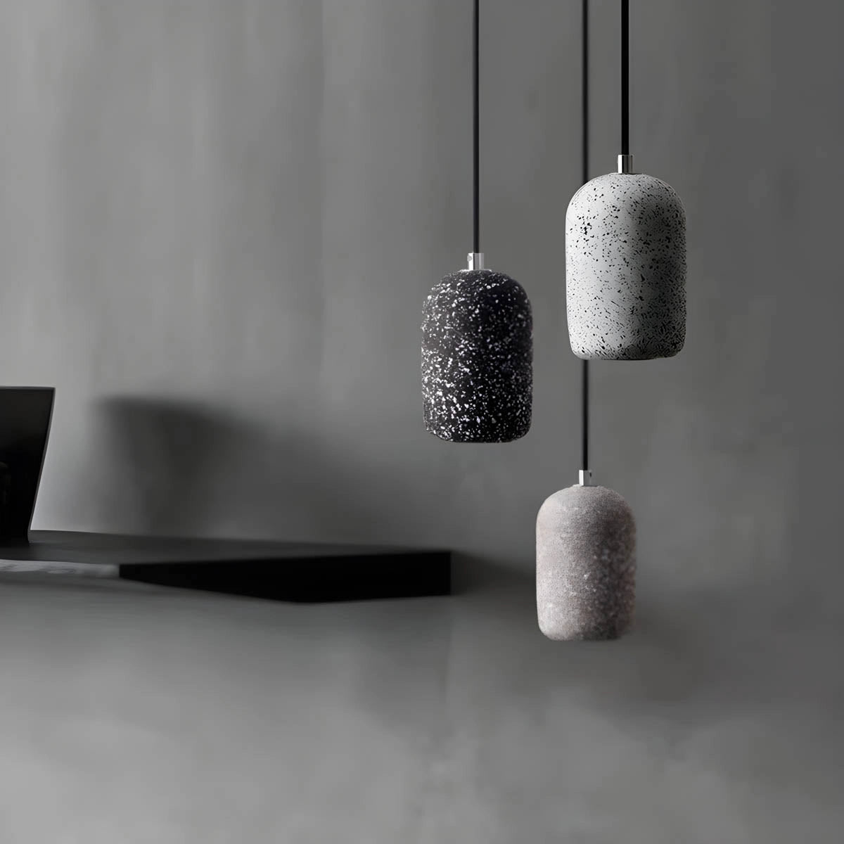 Modern textured concrete pendant lights in a sleek, rectangular design with grey and silver tones, hanging in a contemporary kitchen setting.