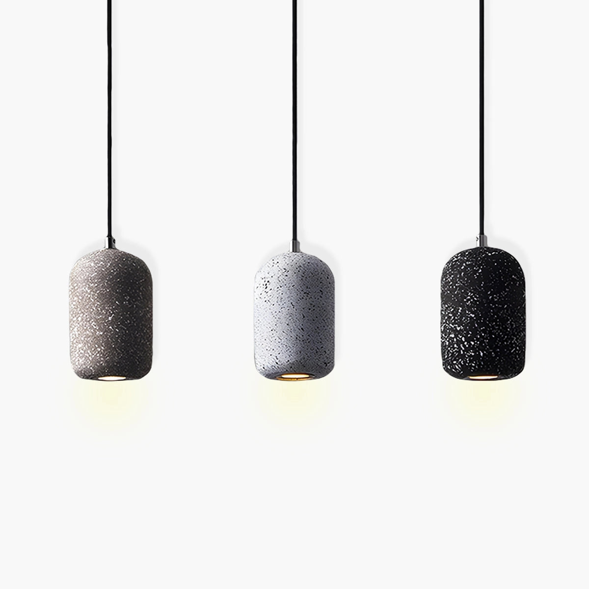 Modern textured concrete pendant lights hanging in a sleek kitchen setting, showcasing their unique design and material properties.
