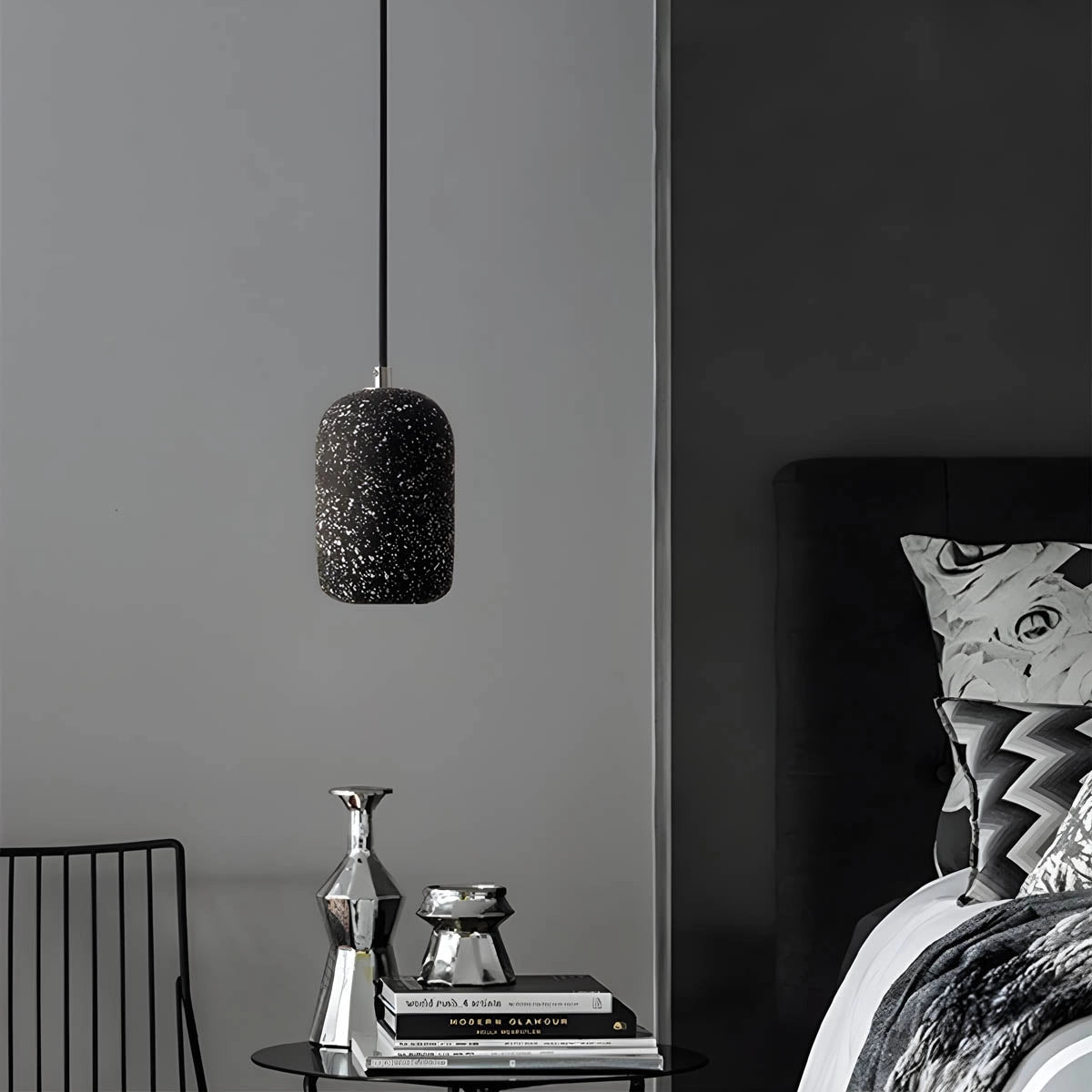 Modern textured concrete pendant lights in a sleek kitchen setting with white, black, and grey elements, showcasing a monochrome style.