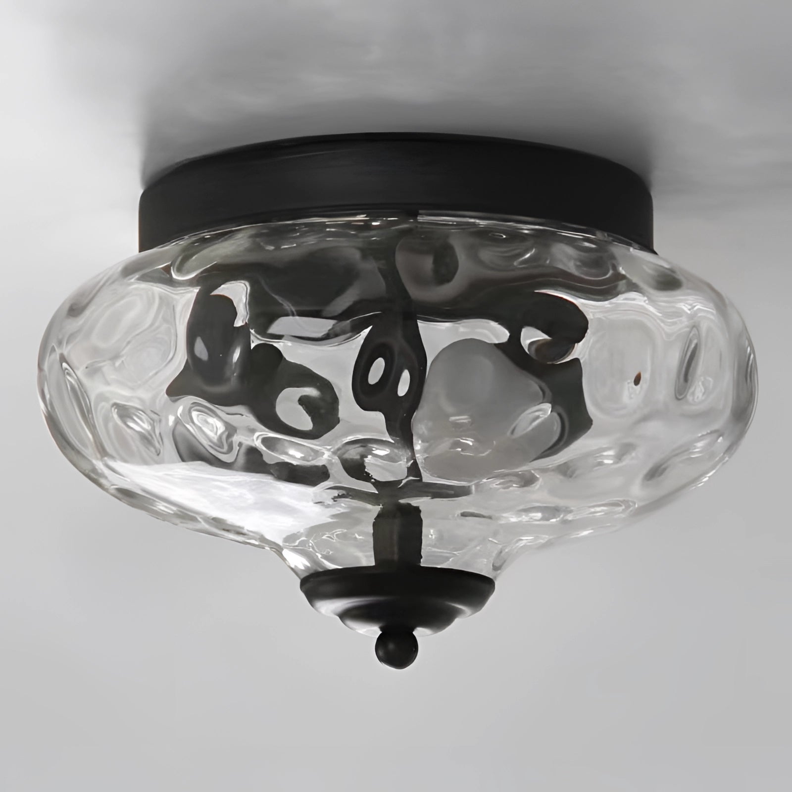 Modern textured glass ceiling light with a swirl pattern design, featuring a metal fixture, ideal for adding a stylish touch to any room.