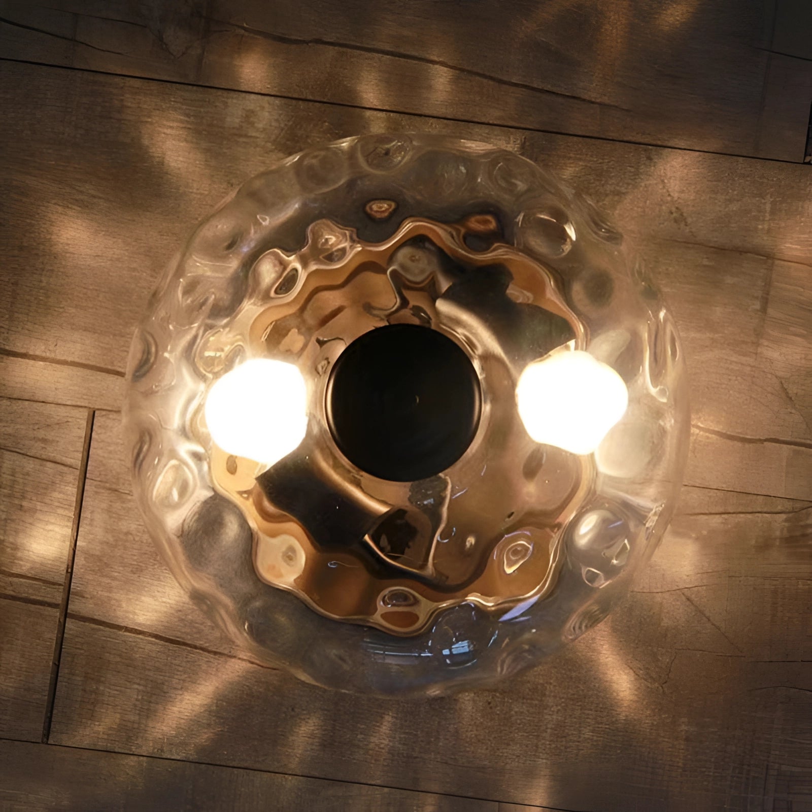 Modern textured glass ceiling light fixture with a swirl pattern design, featuring a circular shape and artistic detailing, set against a background that highlights its elegant and contemporary style.