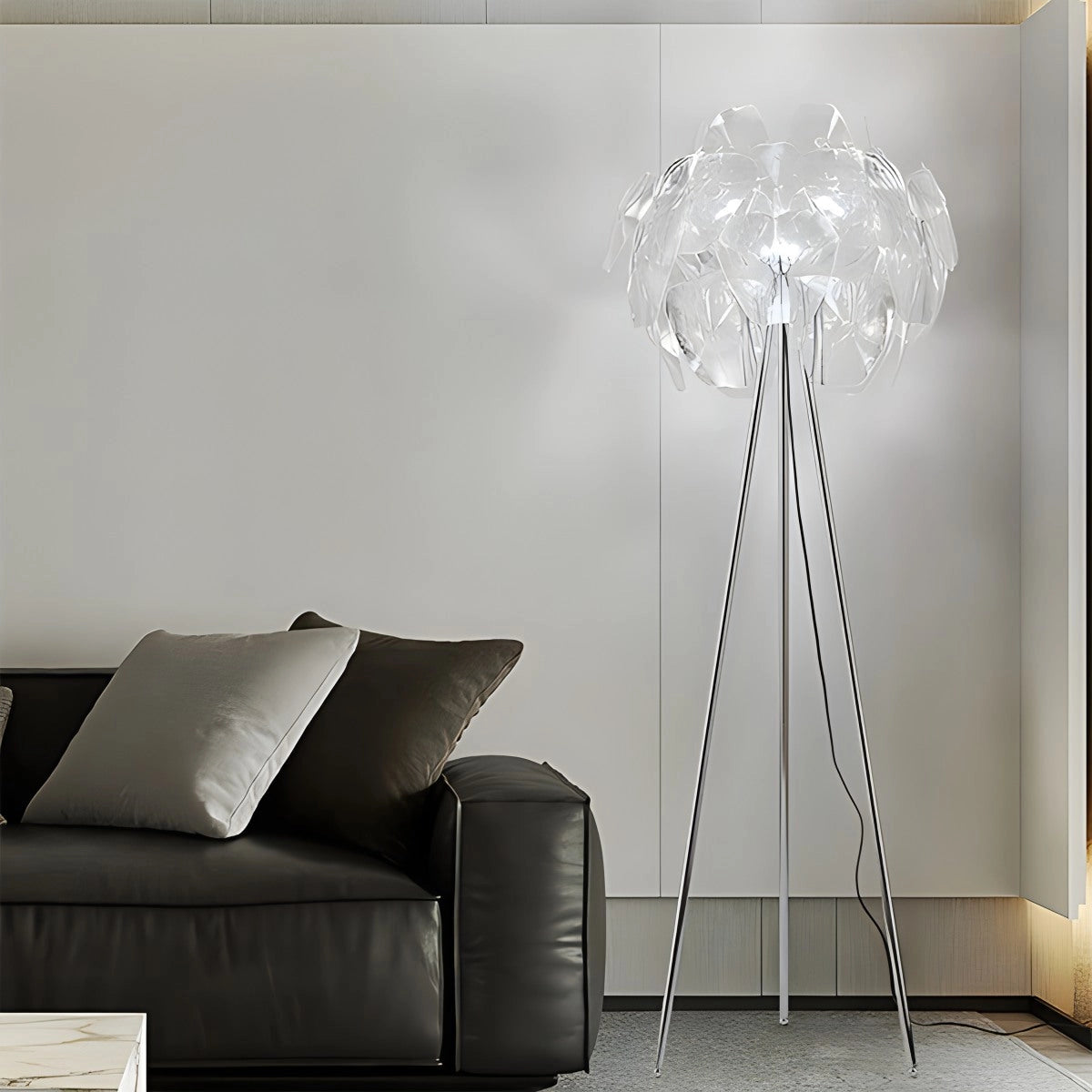 Modern Tri-Leg Floor Lamp with Petal Design and Clear Acrylic Globe in a contemporary living room featuring a grey couch, wooden table, and stylish interior design.