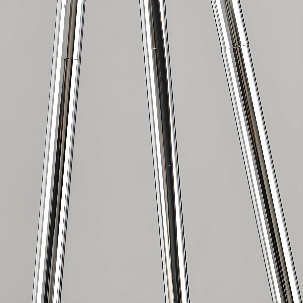 Modern tri-leg floor lamp with a petal design and clear acrylic globe, featuring a sleek metal frame and glass elements.