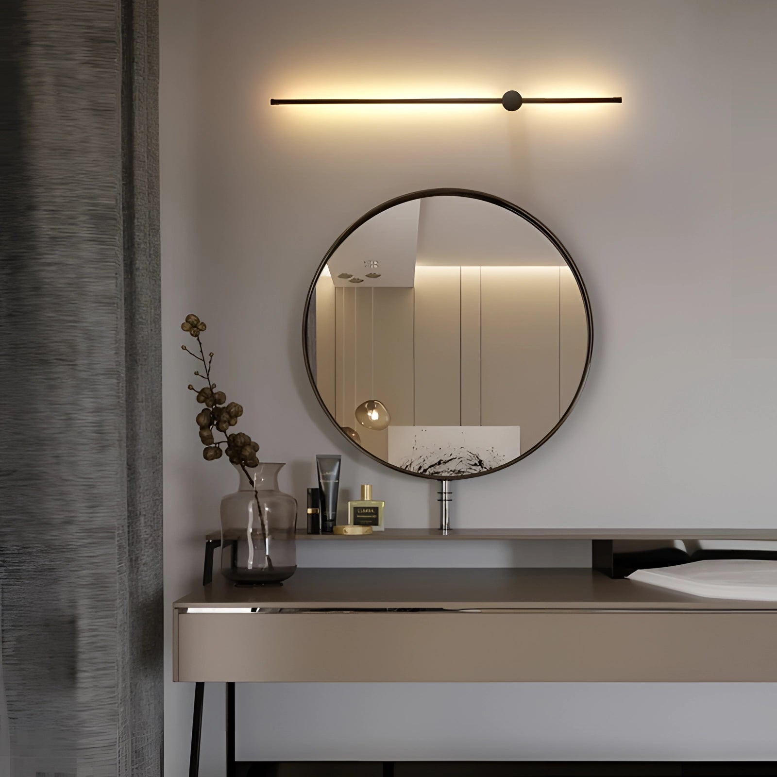 Modern vertical coat rack with a minimalist design in black, measuring 10 x 100 cm, mounted on a wooden wall panel. The decor features a sleek, cool white finish, complementing a contemporary bathroom setting with a nearby makeup mirror and sink.