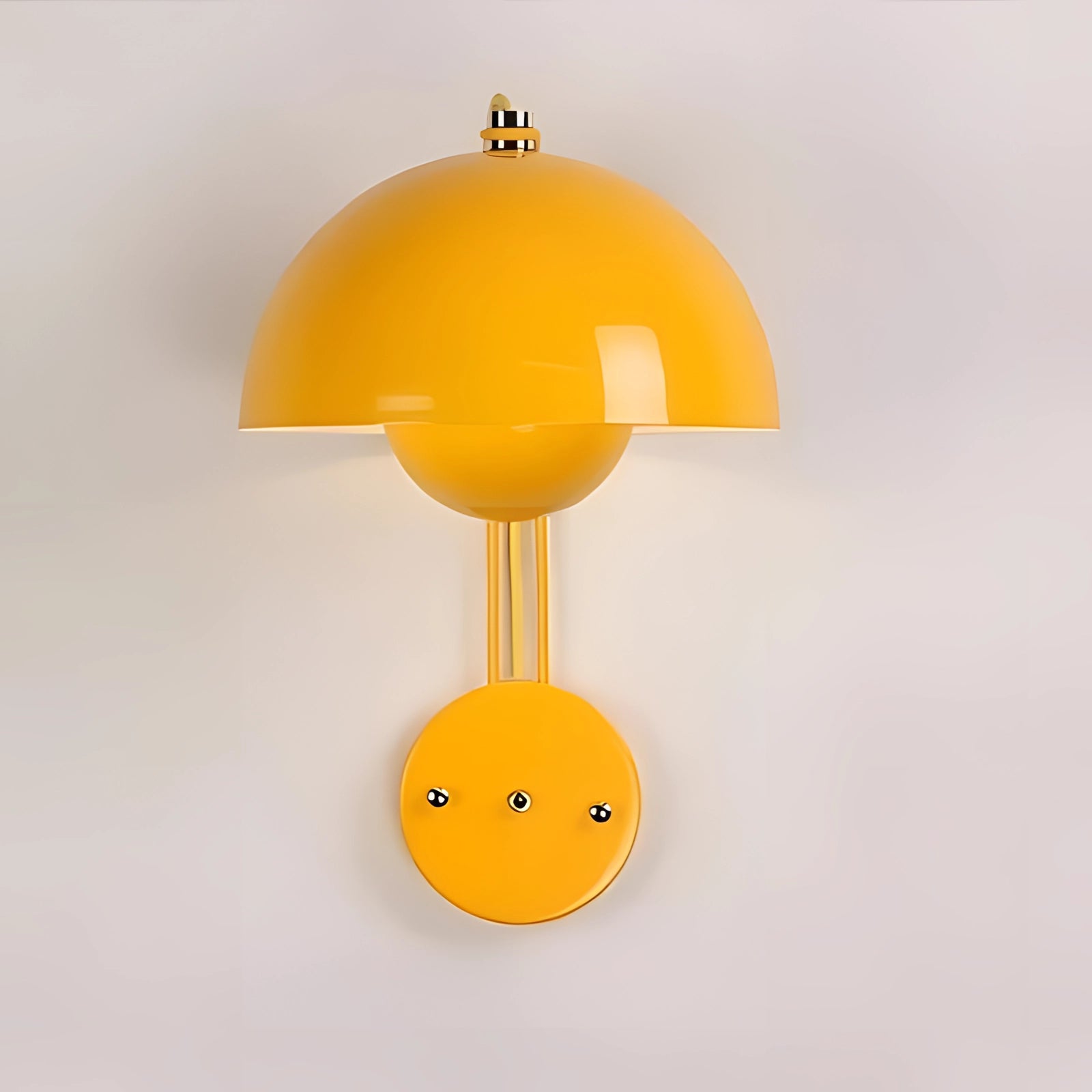 Modern white dome wall lamp with a minimalist design, featuring a soft yellow hue, mounted on a wall.