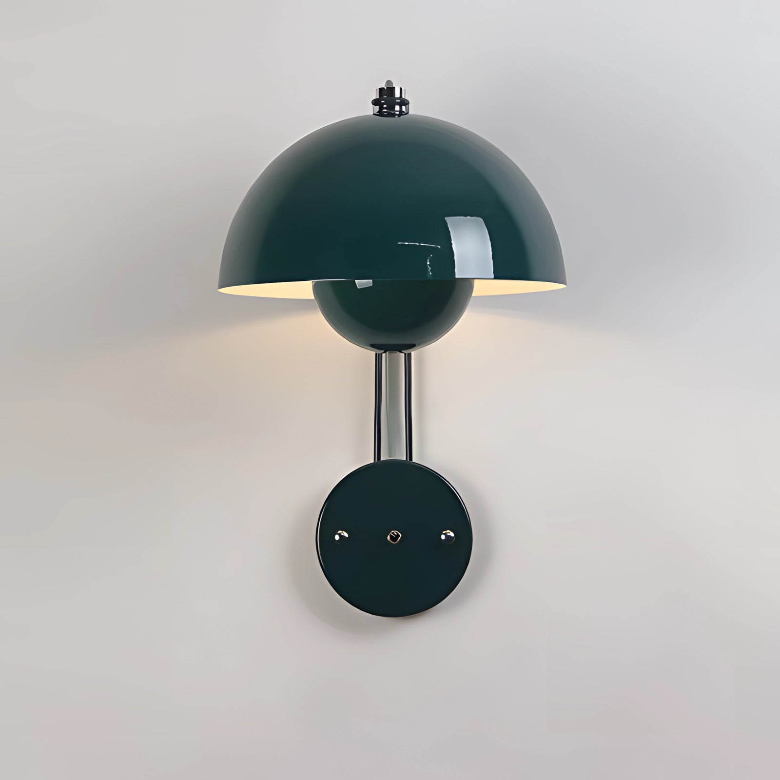 A minimalist designer wall lamp featuring a modern white dome shape with a green accent, mounted on a wall beside a stylish table. The lamp's sleek design and soft illumination create a contemporary artistic ambiance in the room.