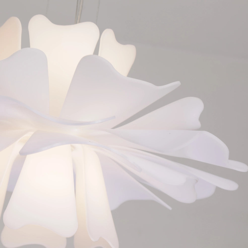 Modern white floral pendant light with decorative blossom design, featuring symmetrical petal patterns resembling a flower, creating a stylish and artistic ceiling lamp.