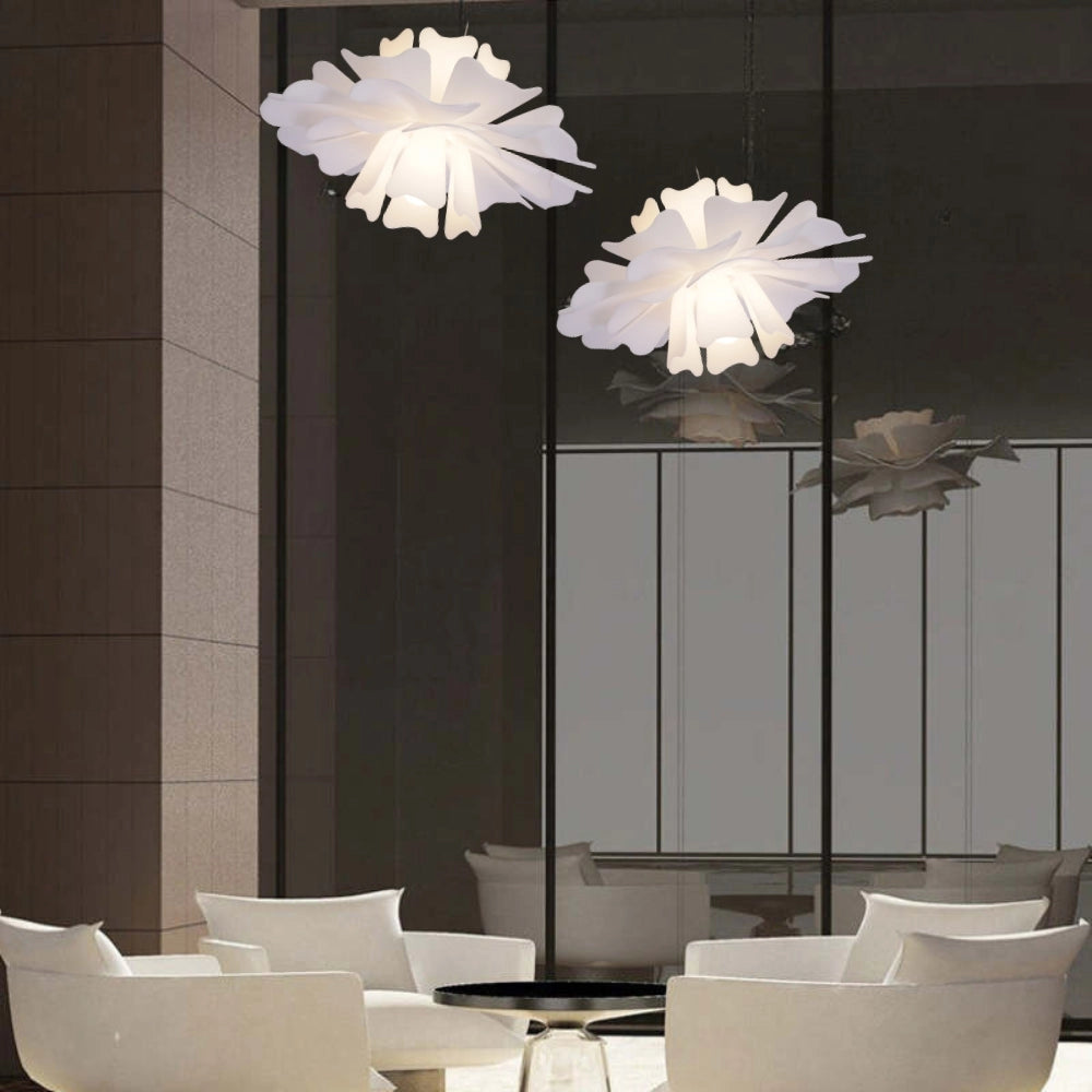 Modern white floral pendant light featuring a decorative blossom design, hanging from the ceiling in a stylish interior setting.