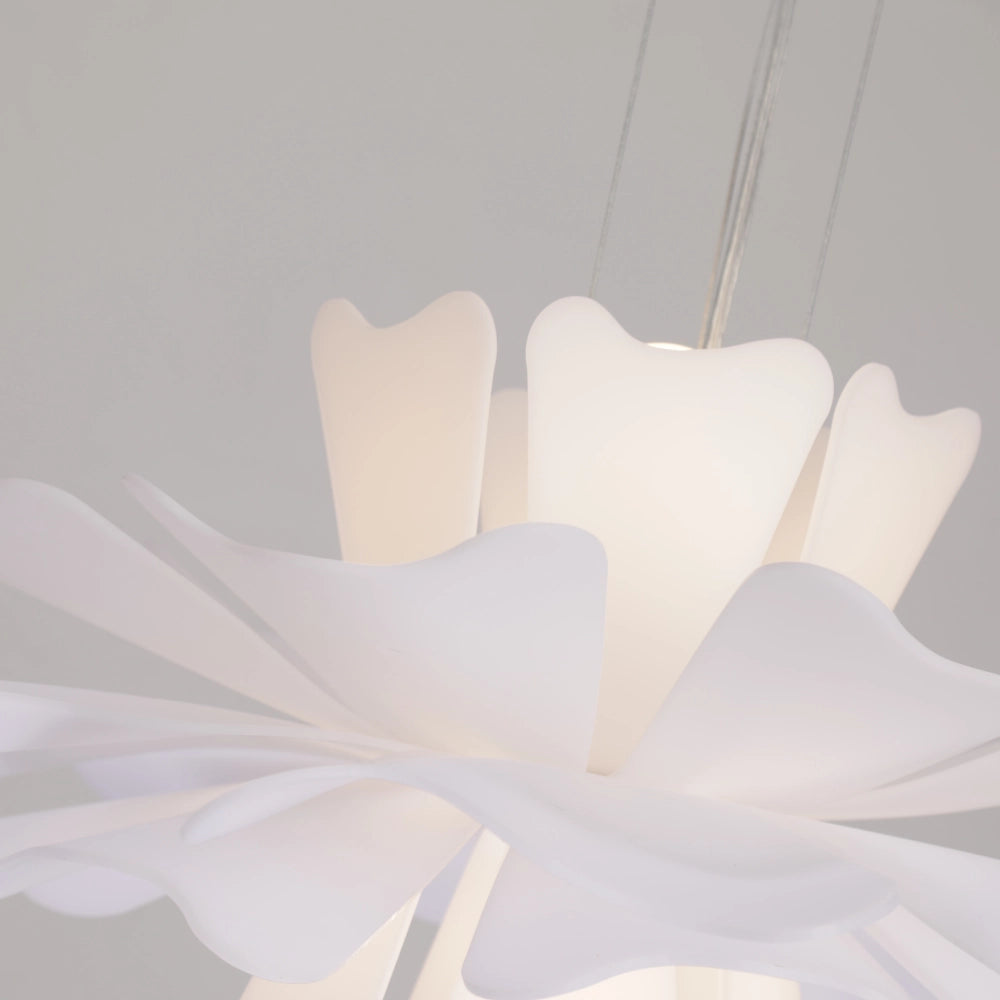 Modern white floral pendant light featuring a decorative blossom design with petal-like elements and symmetrical pattern, resembling paper art against a soft background.