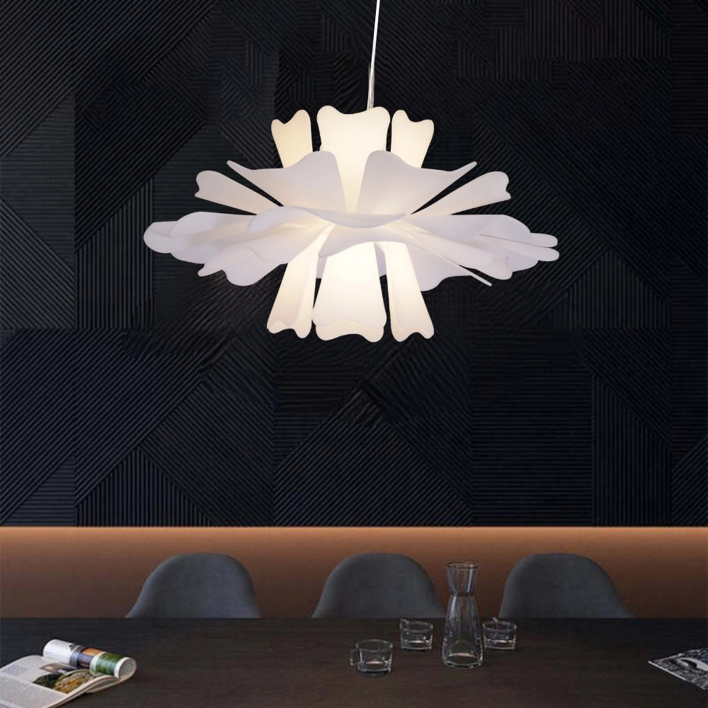 Modern white floral pendant light with a decorative blossom design, measuring 15.7 inches, hanging from a ceiling in a stylish interior setting.