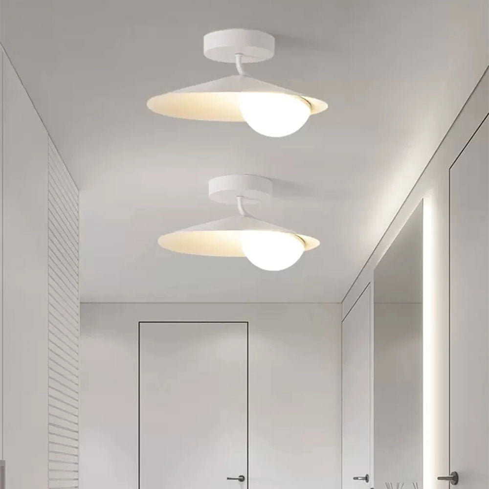 Modern white flush mount ceiling light with a minimalist matte finish, featuring a circular design and white glass shade, mounted on a ceiling.