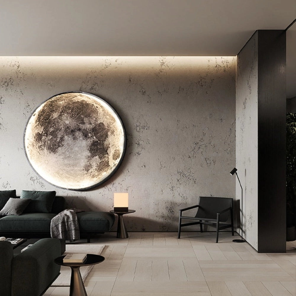 A modern interior space featuring a luxurious Moon Ceiling Light LED fixture, illuminating a stylish setting with a grey couch, wooden flooring, and contemporary furniture elements.