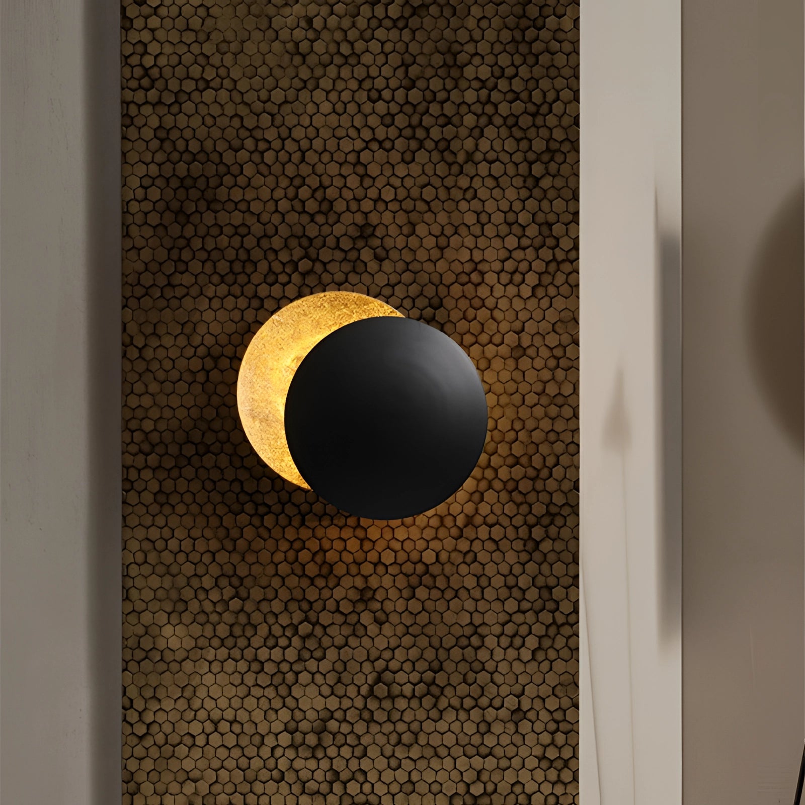 Luxury gold moon-phase wall light in a designer lunar sconce shape, featuring a brown rectangular wooden base with beige and gold accents.