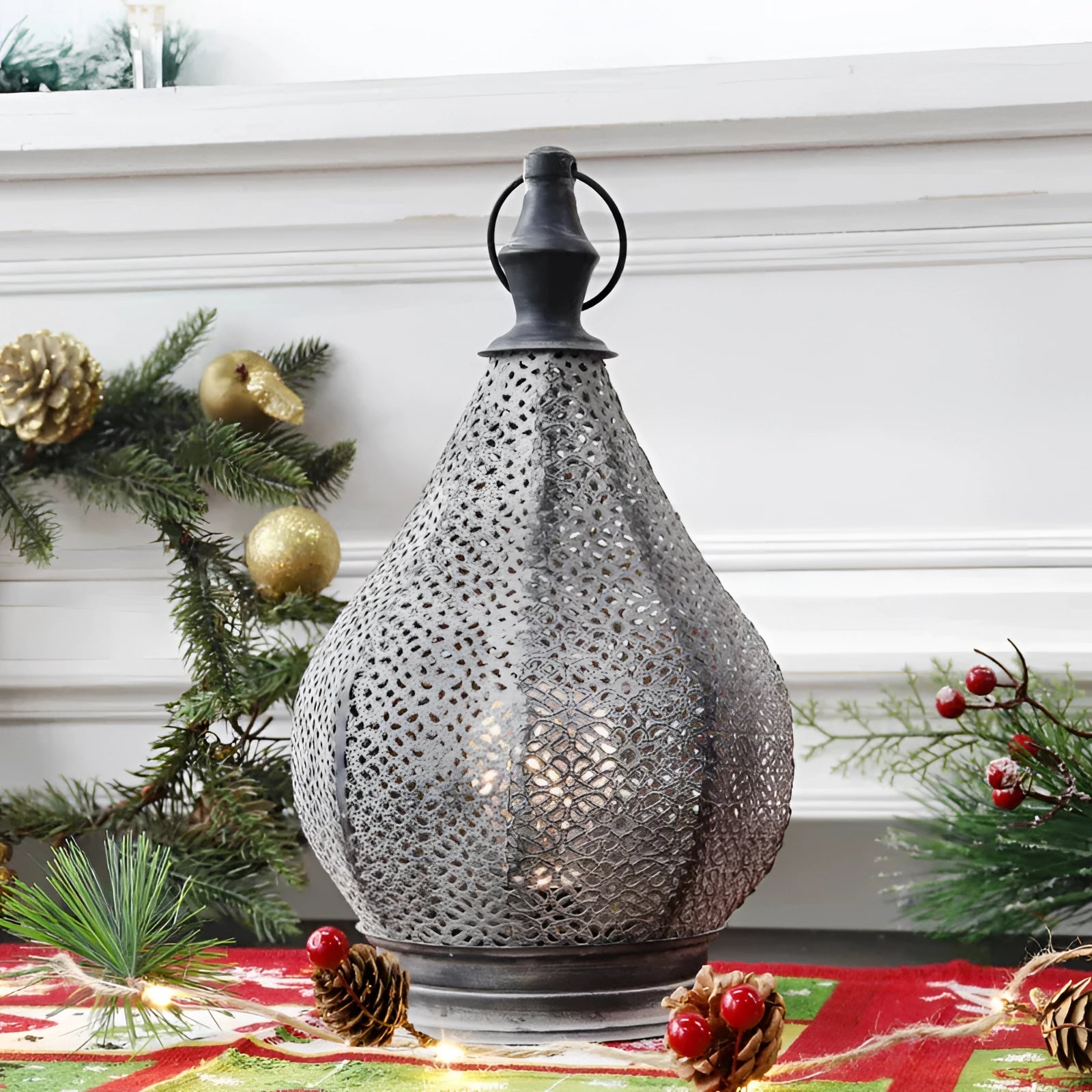 Handmade Moroccan metal table lamp with ethnic design, creating ambient lighting in a cozy interior setting.