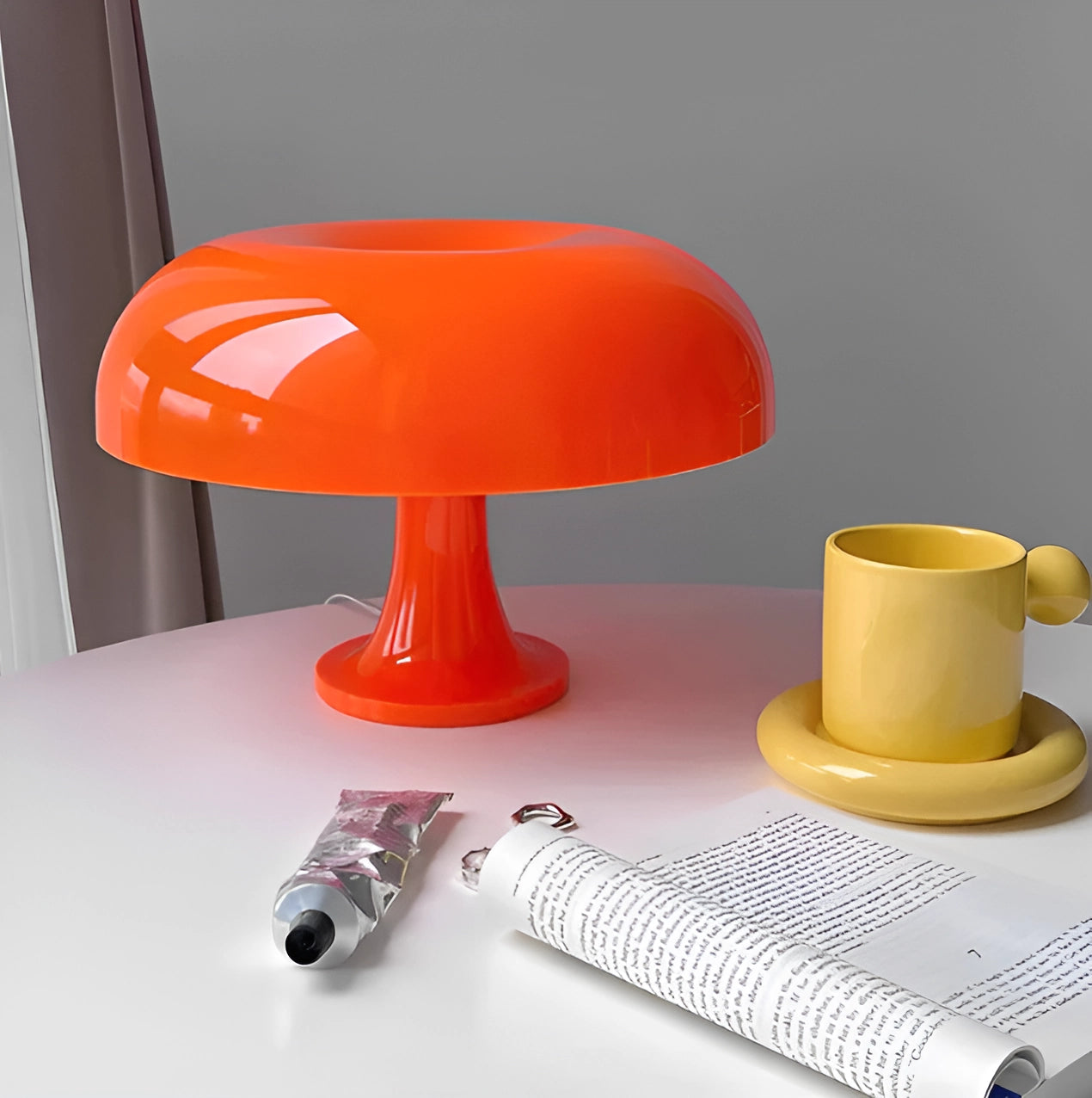 Orange mushroom-shaped lamp in a retro 70s style, mid-century design, placed on a table.