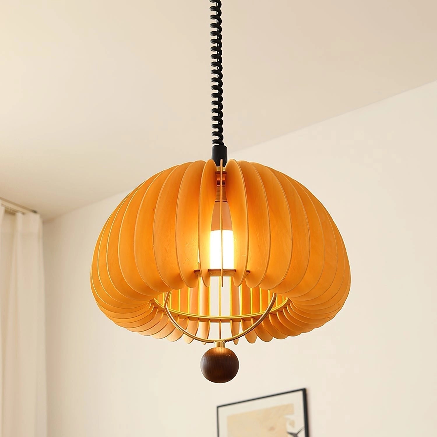 Orange Scandinavian Ribbed Pendant Light hanging in a modern kitchen setting with an amber hue, wooden accents, and a symmetrical design.