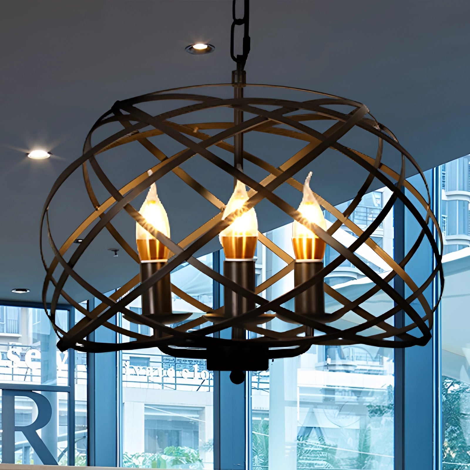 Black metal cage orb chandelier with industrial design, featuring a symmetrical ceiling fixture with glass and metal elements.