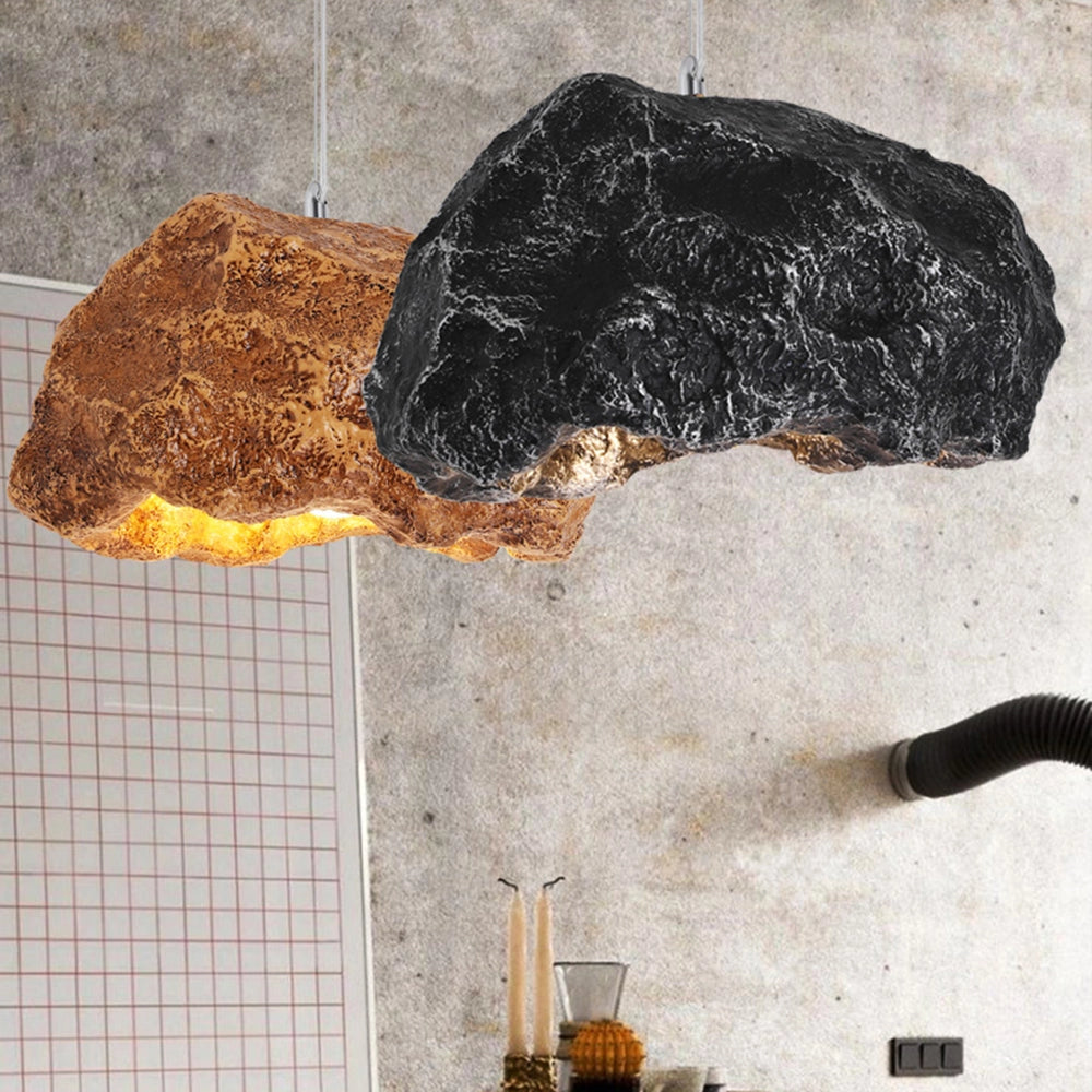 Organic stone pendant light hanging from a ceiling, featuring a modern industrial design with a concrete texture and warm wood accents, casting soft shades on the wall.