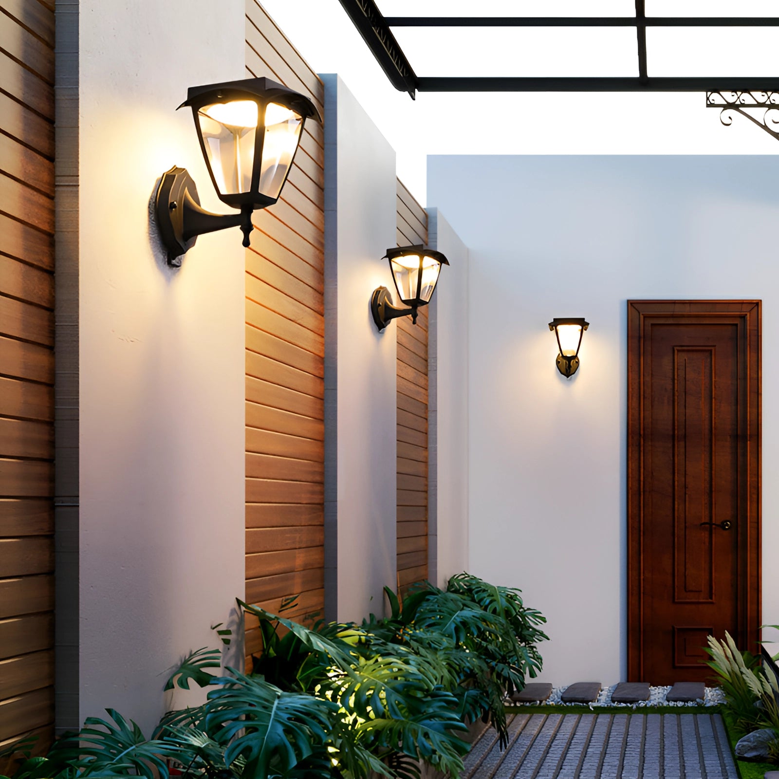 Outdoor LED wall lantern with energy-efficient and water-resistant design in black finish, mounted on exterior wall near a door with plants and greenery in the background.