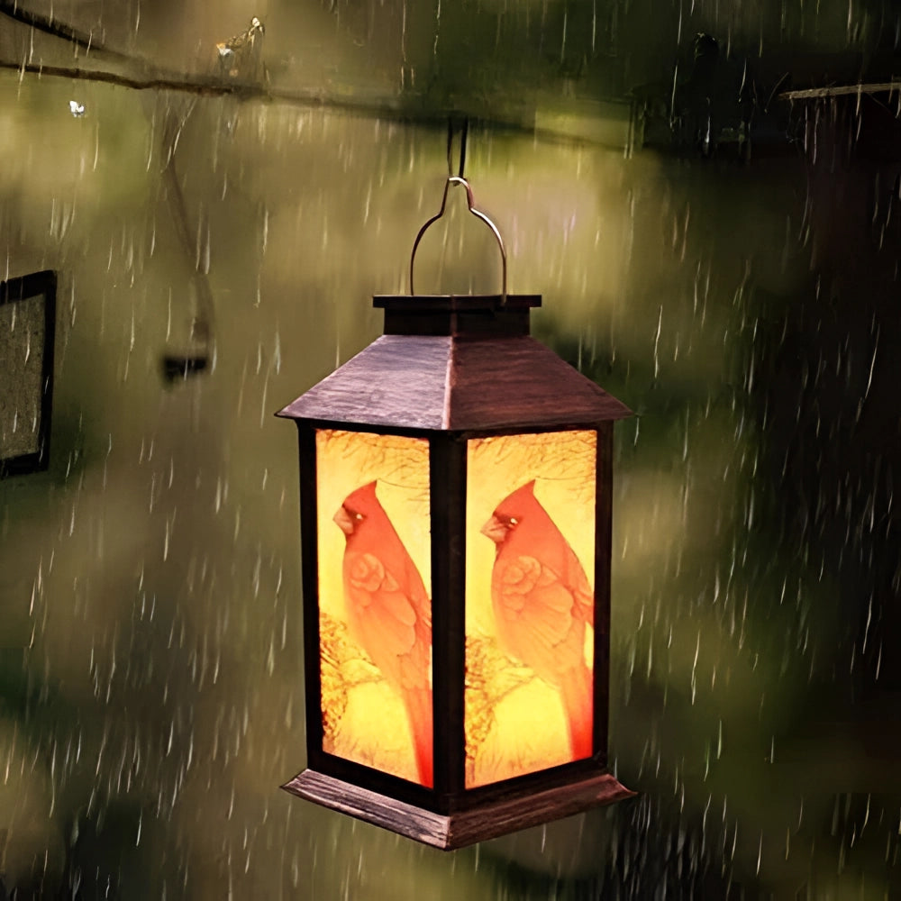Outdoor vintage-style bird lantern with an amber glow, featuring a weather-resistant design suitable for wall mounting, resembling traditional street lighting with rectangular shape, set against a wood backdrop.