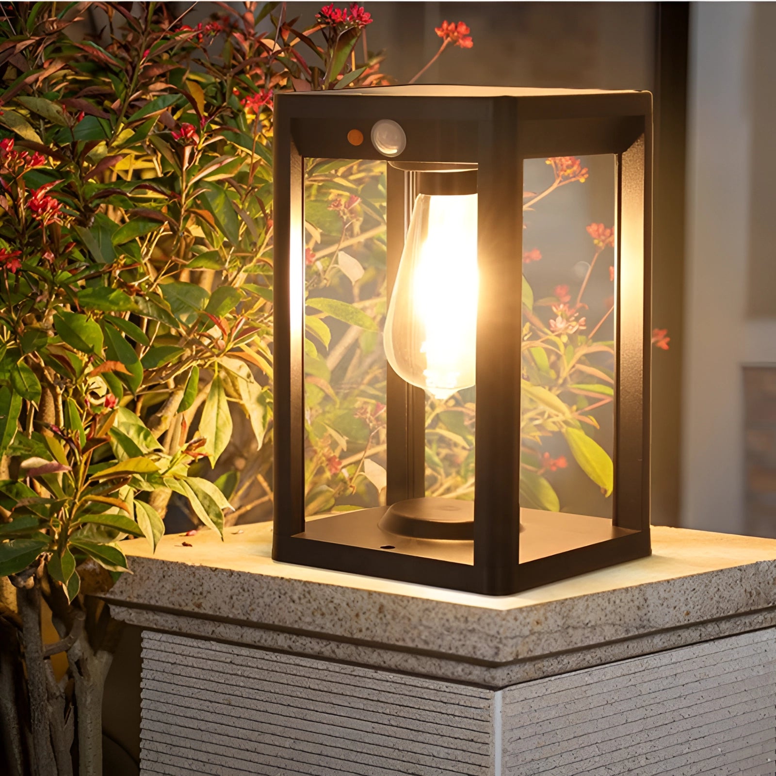 Outdoor solar lantern LED garden light illuminating with warm amber glow, featuring a weatherproof rectangular wooden design, positioned near plants and walls in an outdoor setting.