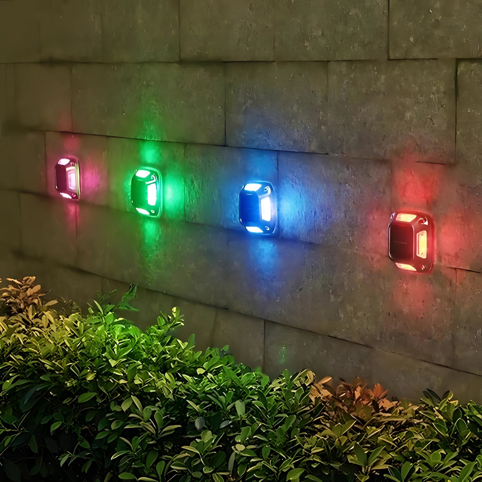 Outdoor solar path lights set displaying vibrant RGB colors, placed along a garden path, surrounded by plants and trees, showcasing their eco-friendly and waterproof design.