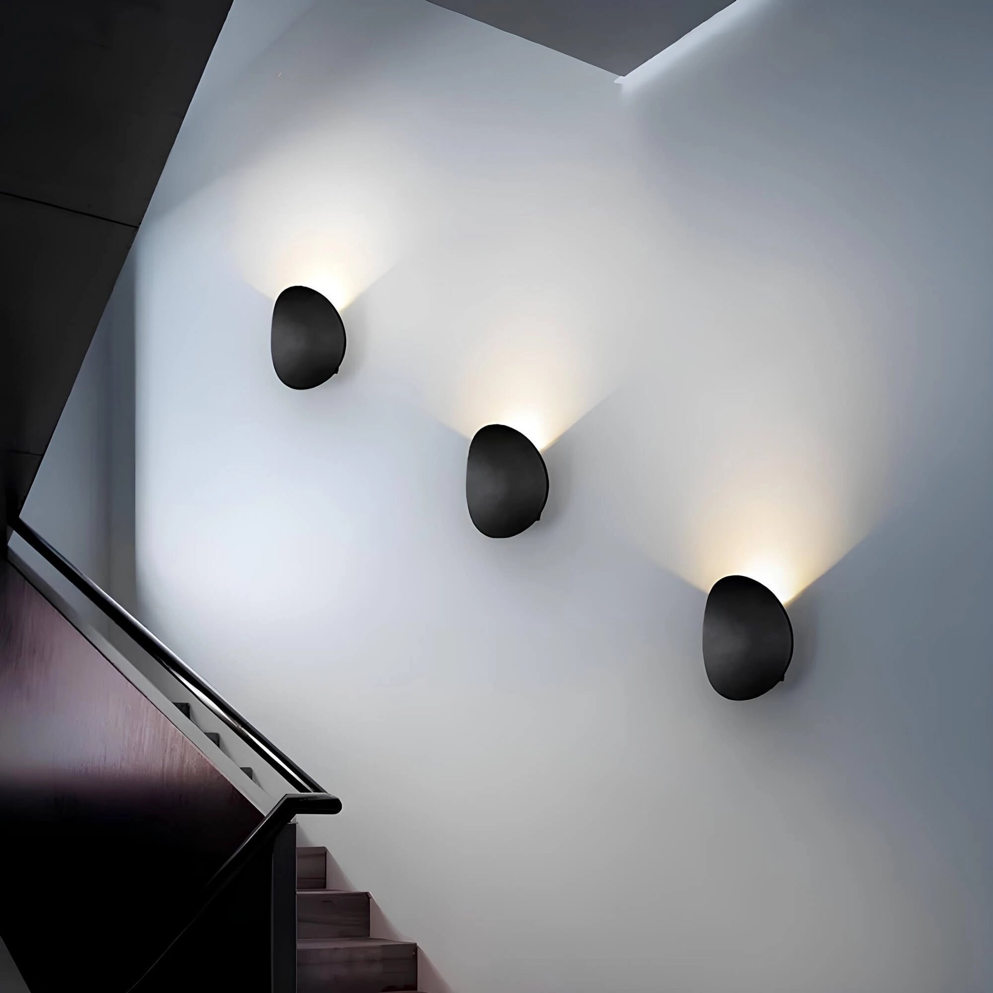Oval wall mirror with a minimalist modern design, displayed in a contemporary room setting showcasing a blend of geometric patterns and symmetry, surrounded by a monochrome color palette and illuminated by a ceiling fixture.