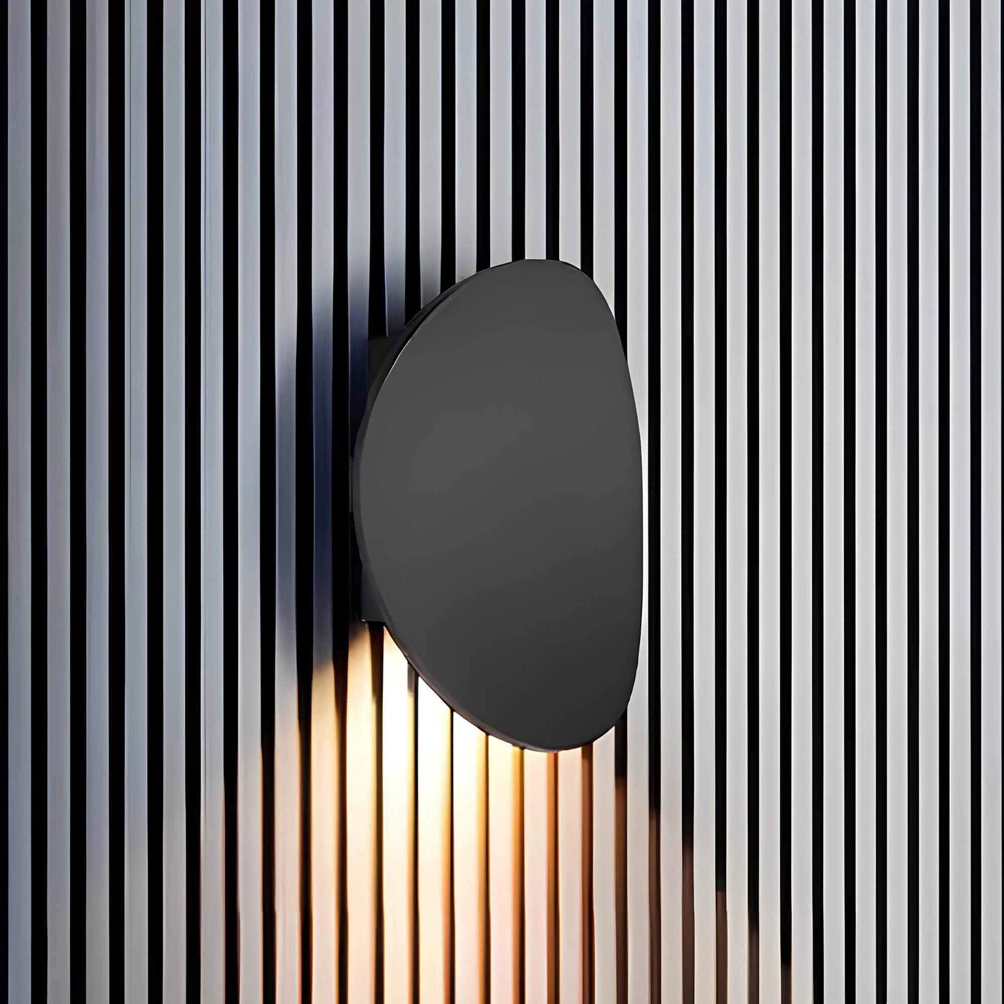 Oval wall mirror with a minimalist modern design, featuring a sleek frame suitable for contemporary decor.