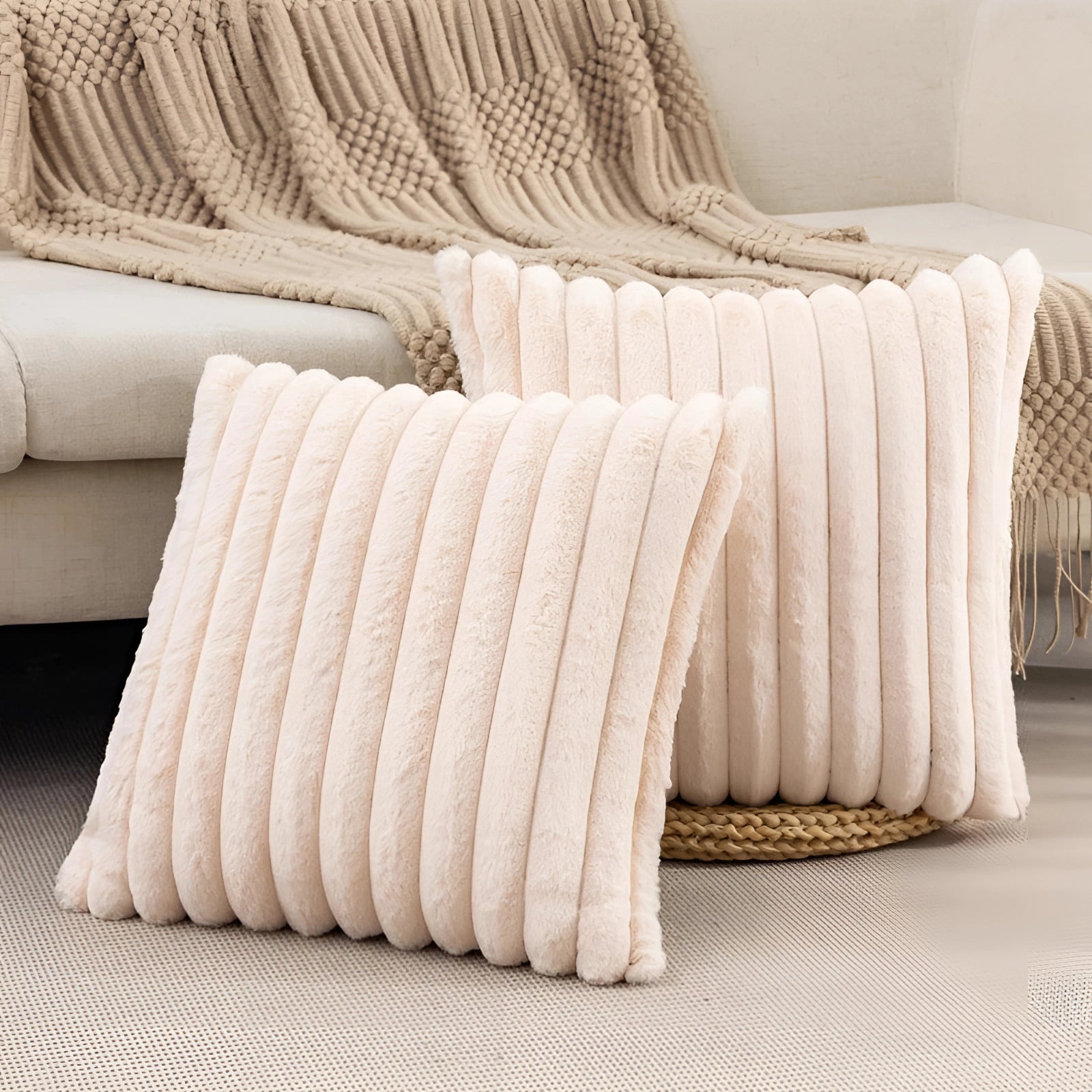 Light yellow ribbed corduroy pillow on a beige couch with wooden flooring in the background.