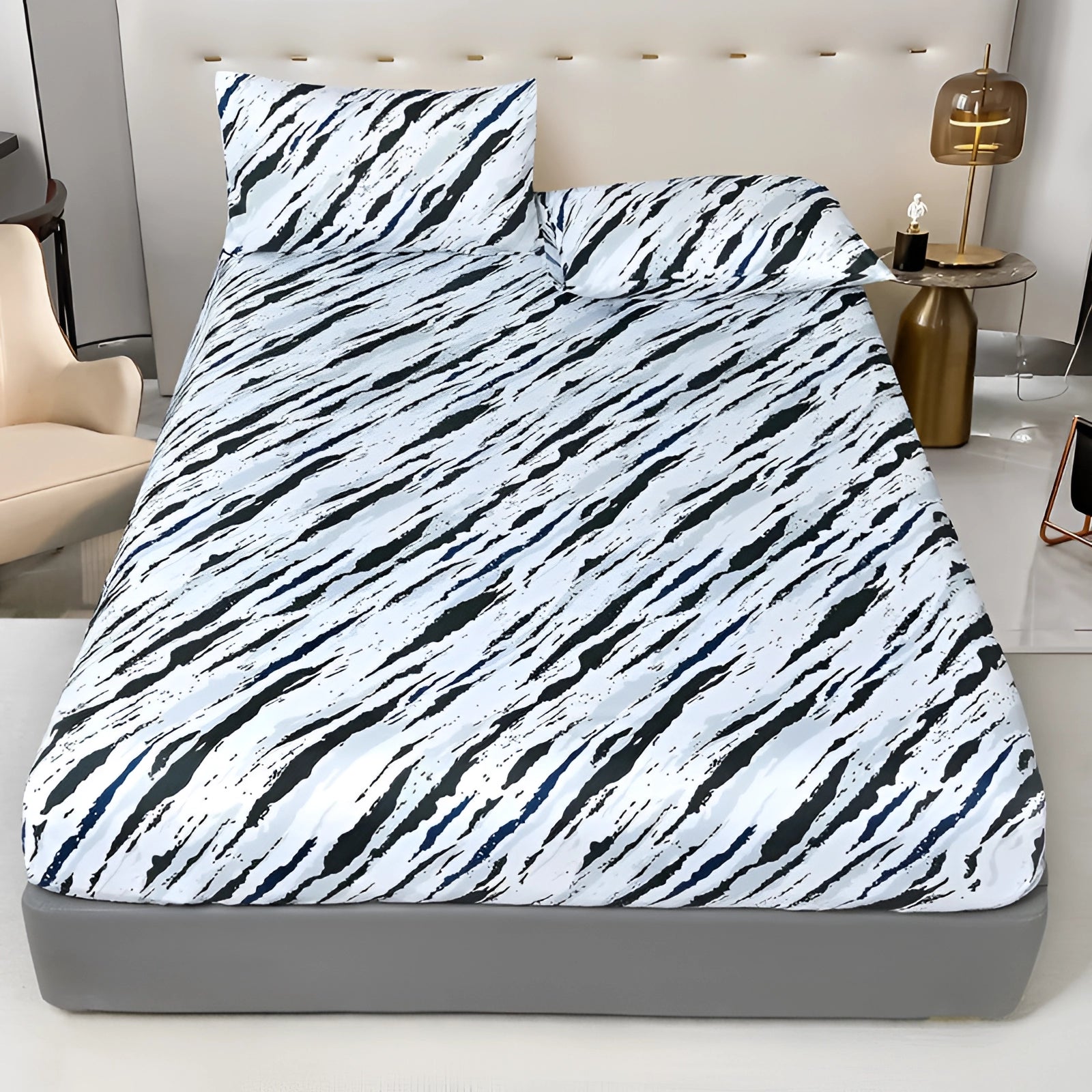 Queen size bed featuring a blue floral duvet cover set with a modern botanical pattern, complemented by matching pillows, set on a grey bed frame.